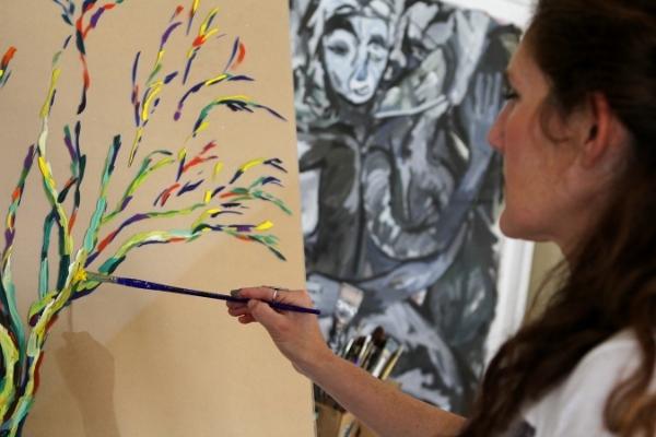 Rachel Shultz working on a reverse acrylic painting